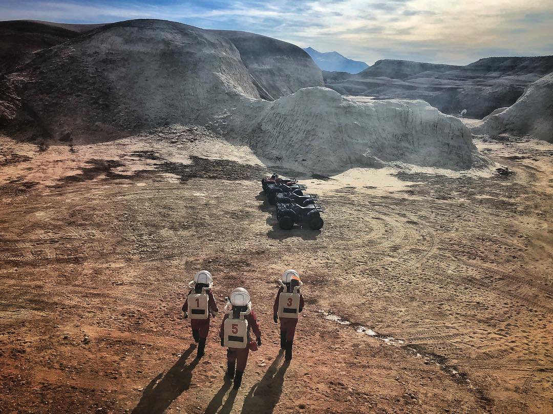 The MDRS 188 Crew walking to the ATVs